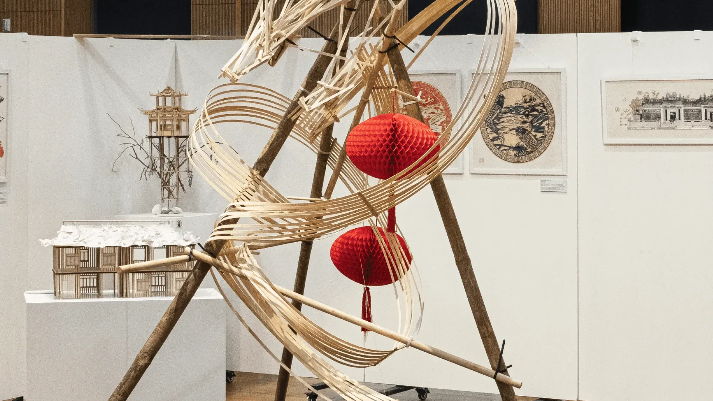 魚躍龍門 Metamorphosis, March 2025, bamboo and balsa, 150 × 150 × 230 cm: the dragon on its black plinth with red lanterns